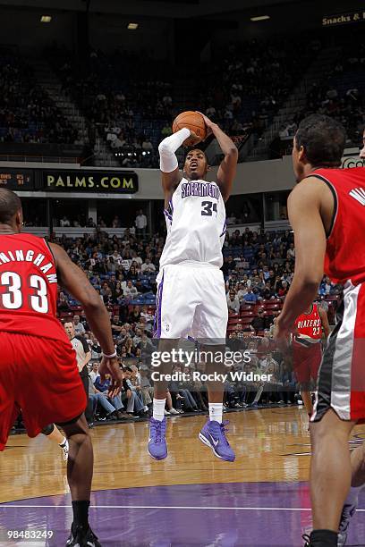 Jason Thompson of the Sacramento Kings shoots a jump shot against Dante Cunningham of the Portland Trail Blazers during the game at Arco Arena on...