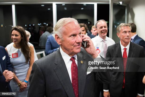 South Carolina Governor Henry McMaster takes a phone call from Sen. Lindsey Graham during a gubernatorial primary runoff election watch party at...