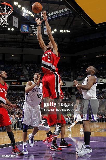 Marcus Camby of the Portland Trail Blazers rebounds against Sean May and Carl Landry of the Sacramento Kings during the game at Arco Arena on April...