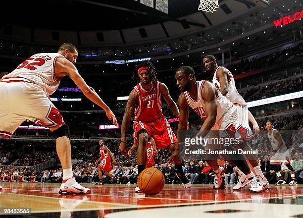 Brad Miller and Ronald Murray of the Chicago Bulls and Jordan Hill of the Houston Rockets move toward a loose ball at the United Center on March 22,...