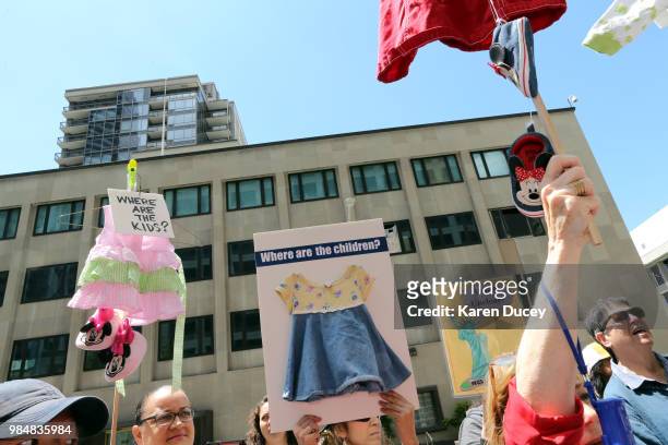 Signs asking about detained migrant children are displayed during a rally supporting immigration activist Maru Mora-Villalpando outside the Seattle...