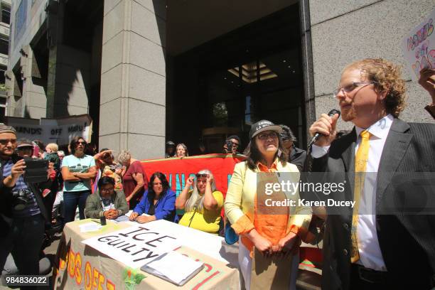 Immigration activist Maru Mora-Villalpando and her attorney Devin Theriot-Orr address the crowd outside the Seattle Immigration Court where...