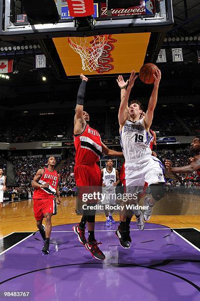 Beno Udrih of the Sacramento Kings shoots a layup against LaMarcus Aldridge of the Portland Trail Blazers during the game at Arco Arena on April 3,...