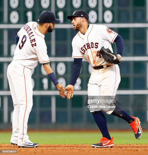 George Springer of the Houston Astros and Marwin Gonzalez celebrate after defeating the Toronto Blue Jays at Minute Maid Park on June 26, 2018 in...