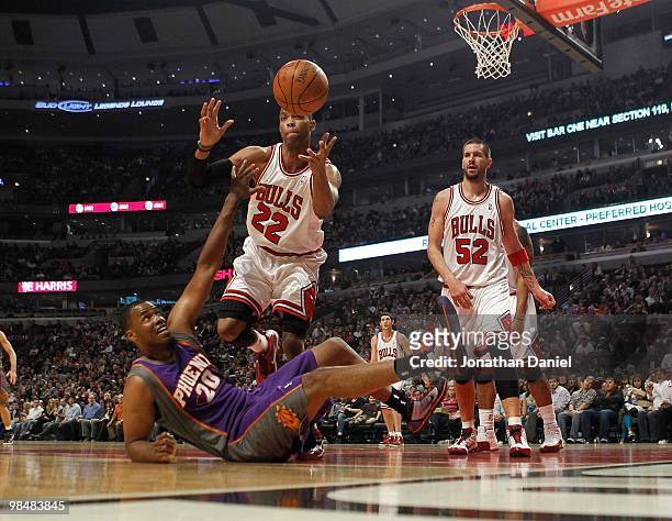 Taj Gibson of the Chicago Bulls goes for a ball lost by Jarron Collins of the Phoenix Suns at the United Center on March 30, 2010 in Chicago,...