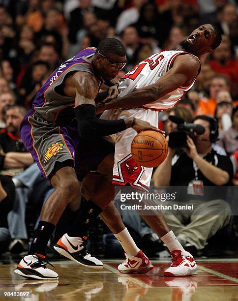 Amar'e Stoudemire of the Phoenix Suns runs into Hakim Warrick of the Chicago Bulls at the United Center on March 30, 2010 in Chicago, Illinois. The...