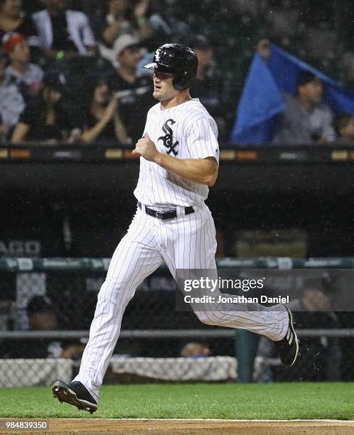 Adam Engel of the Chicago White Sox scores a run on a triple by teammate Yoan Moncada in the 3rd inning against the Minnesota Twins at Guaranteed...