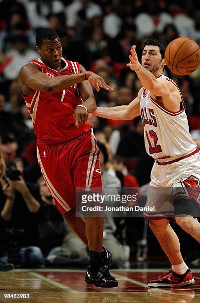 Kyle Lowery of the Houston Rockets passes the ball under pressure from Kirk Hinrich of the Chicago Bulls at the United Center on March 22, 2010 in...