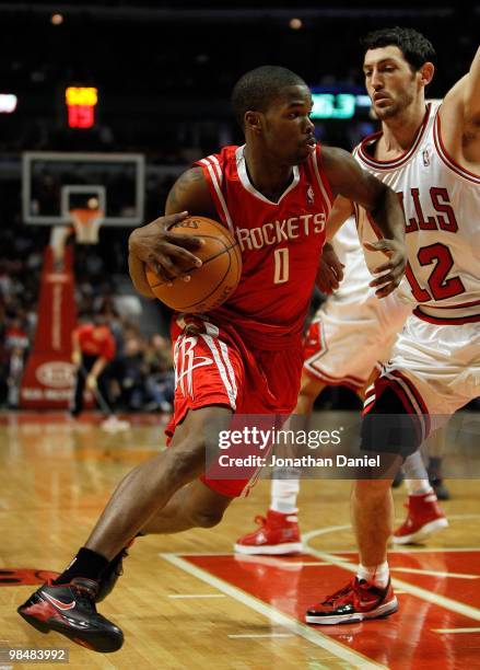 Aaron Brooks of the Houston Rockets drives around Kirk Hinrich of the Chicago Bulls at the United Center on March 22, 2010 in Chicago, Illinois. The...