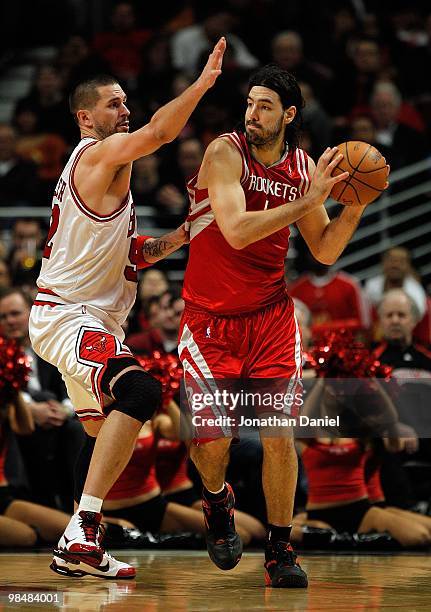 Luis Scola of the Houston Rockets looks to pass under pressure from Brad Miller of the Chicago Bulls at the United Center on March 22, 2010 in...