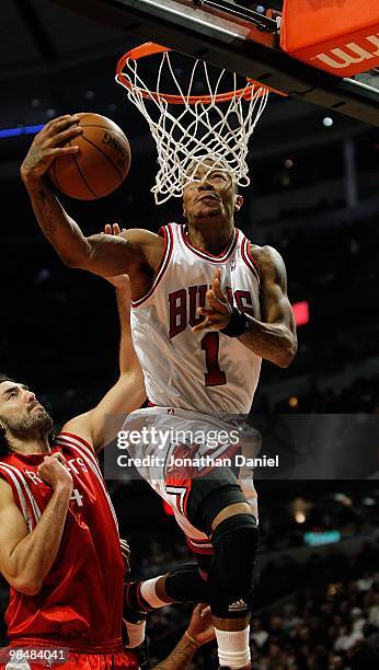 Derrick Rose of the Chicago Bulls goes up for a shot against Luis Scola of the Houston Rockets at the United Center on March 22, 2010 in Chicago,...