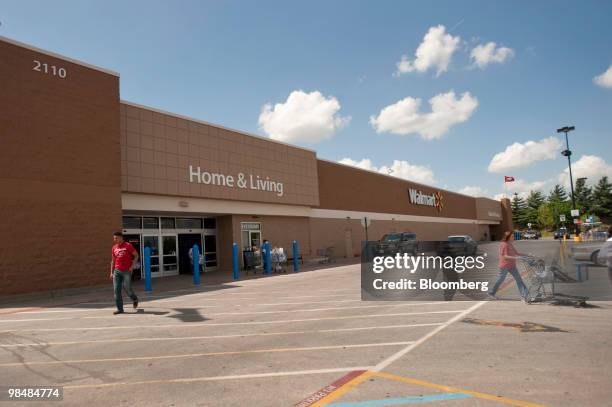 Shoppers leave the Wal-Mart Store No. 1 in Rogers, Arkansas, U.S., on Thursday, April 15, 2010. Wal-Mart Stores Inc., the world's largest retailer,...