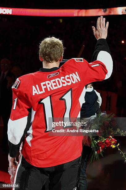 Daniel Alfredsson of the Ottawa Senators waves to the crowd during a celebration to honour Alfredsson's 1000 career NHL games prior to a game against...