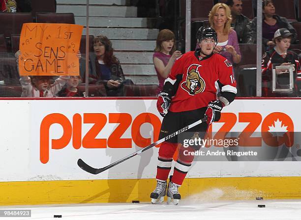 Bobby Butler of the Ottawa Senators skates during warmups in his NHL debut against the Carolina Hurricanes as a young fan holds a sign at the glass...