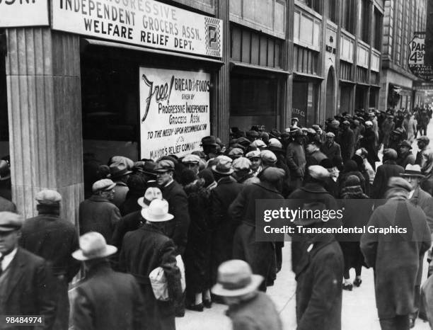 Crowd forms outside the office of the Progressive Independent Grocers Association which gives out bread and food to the needy, New York, 1932.