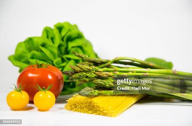 pasta, asparagus, tomatoes, cranberry, lettuce isolated over white. - hadi stock pictures, royalty-free photos & images