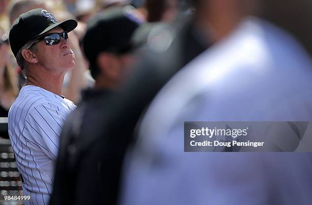 Manager Jim Tracy of the Colorado Rockies watches the action from the dugout against the New York Mets at Coors Field on April 15, 2010 in Denver,...