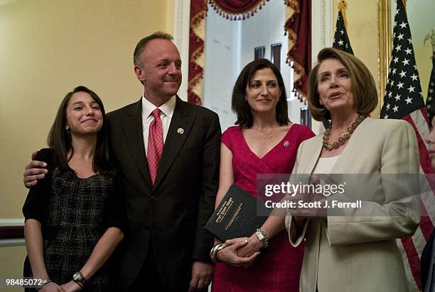 Rep. Ted Deutch, D-Fla., with his family and House Speaker Nancy Pelosi, D-Calif., during a photo op after his swearing in on the House floor. Left...