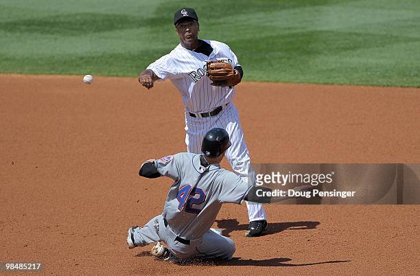 Second baseman Melvin Mora of the Colorado Rockies turns a double play on Jason Bay of the New York Mets on a grounder by Jeff Fancoeur to Troy...