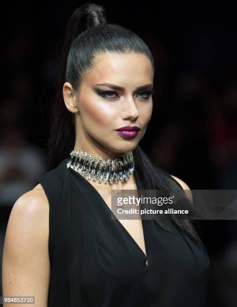 Brazilian model Adriana Lima presents a fashion creation as she walks across the catwalk during the Maybelline Urban Catwalk show at the...