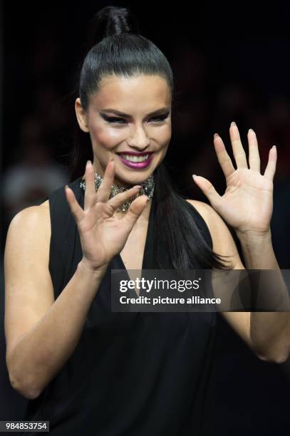 Brazilian model Adriana Lima walks across the catwalk during the Maybelline Urban Catwalk show at the Mercedes-Benz Fashion Week in Berlin, Germany,...