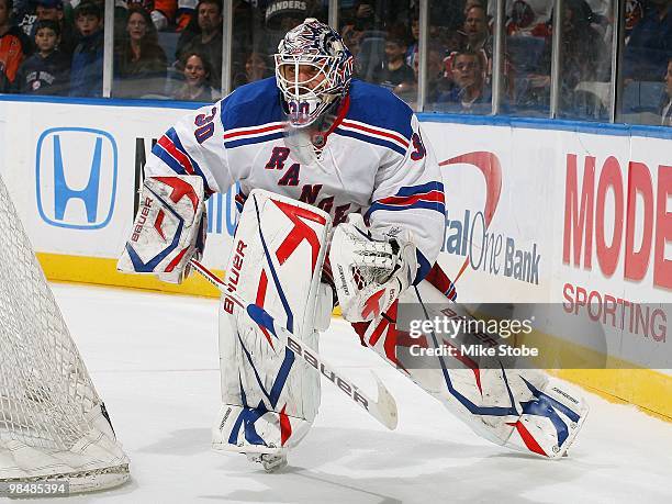 Goaltender Henrik Lundqvist of the New York Rangers plays the puck from behind the net against the New York Islanders on March 30, 2010 at Nassau...