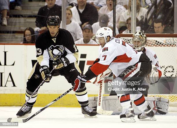 Bill Guerin of the Pittsburgh Penguins and Matt Cullen of the Ottawa Senators battle for puck possession in front of Brian Elliott of the Ottawa...