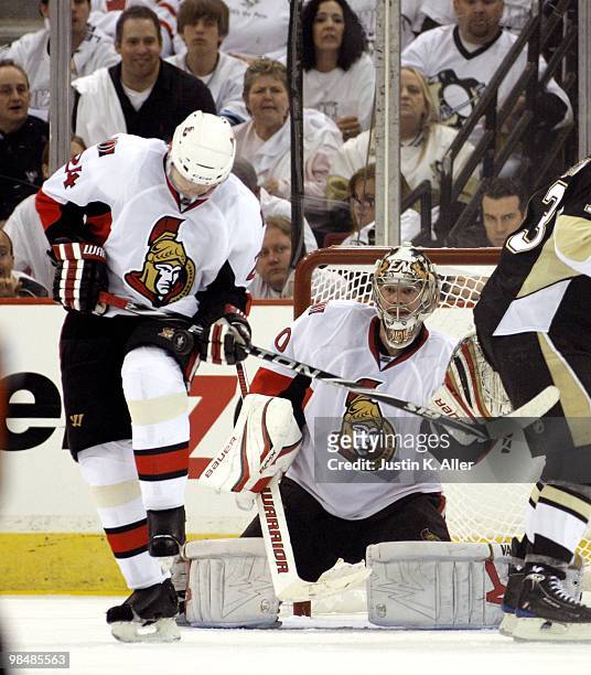 Anton Volchenkov of the Ottawa Senators blocks a shot as Brian Elliott protects the net against the Pittsburgh Penguins in Game One of the Eastern...