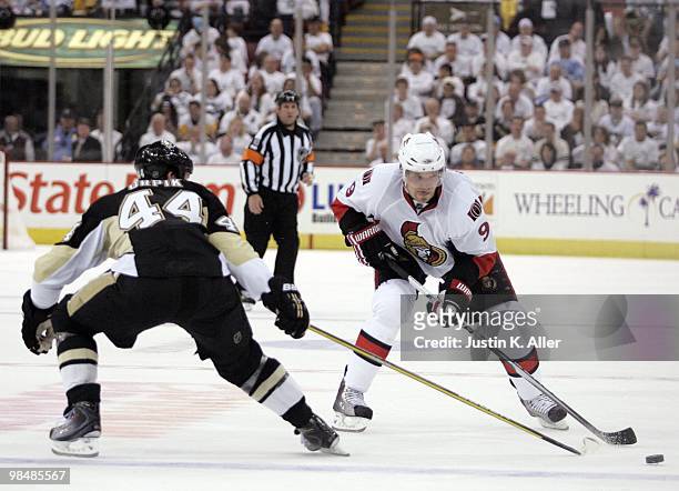 Milan Michalek of the Ottawa Senators handles the puck in front of Brooks Orpik of the Pittsburgh Penguins in Game One of the Eastern Conference...