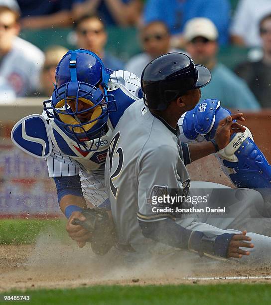 Geovany Soto of the Chicago Cubs, wearing a number 42 jersey in honor of Jackie Robinson, tags out Alcides Escobar of the Milwaukee Brewers, also...