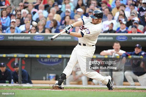 Jason Kubel of the Minnesota Twins hits the first home run ever at Target Field during the Opening Day game against the Boston Red Sox at Target...