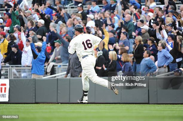 Jason Kubel of the Minnesota Twins rounds the bases after hitting the first home run ever at Target Field during the Opening Day game against the...