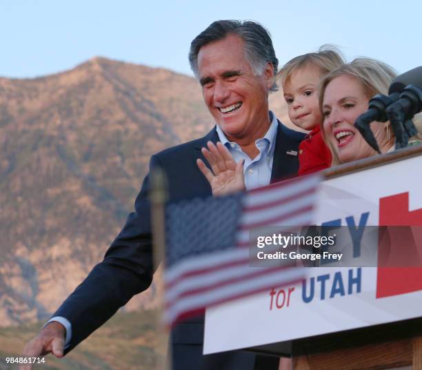 Mitt Romney his grandson Dane Romnay and his wife Ann waves to supporters and declares victory on June 26, 2018 in Orem, Utah. Romney was declared...