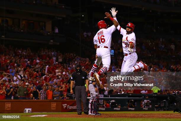 Kolten Wong and Jose Martinez of the St. Louis Cardinals celebrate after Martinez's three-run home run against the Cleveland Indians in the second...