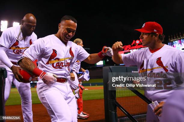 Kolten Wong of the St. Louis Cardinals is congratulated by manager Mike Matheny of the St. Louis Cardinals after hitting a two-run home run against...