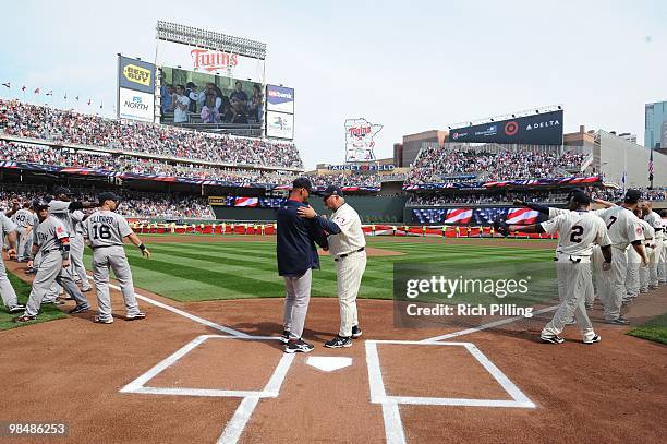 Ron Gardenhire, manager of the Minnesota Twins, right and Terry Francona, manager of the Boston Red Sox shake hands prior to the Opening Day game...