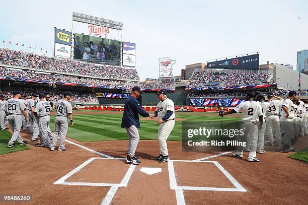 Ron Gardenhire, manager of the Minnesota Twins, right and Terry Francona, manager of the Boston Red Sox shake hands prior to the Opening Day game...