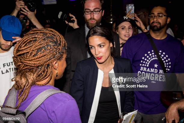 Progressive challenger Alexandria Ocasio-Cortez celebrartes with supporters at a victory party in the Bronx after upsetting incumbent Democratic...