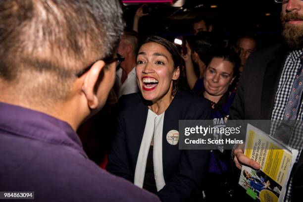 Progressive challenger Alexandria Ocasio-Cortez celebrartes with supporters at a victory party in the Bronx after upsetting incumbent Democratic...