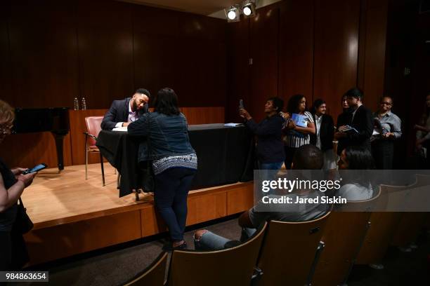 Ndaba Mandela signs a copy of his book at after In Conversation With Lydia Polgreen, Editor-in-Chief, HuffPost and Ndaba Mandela, Grandson Of Nelson...