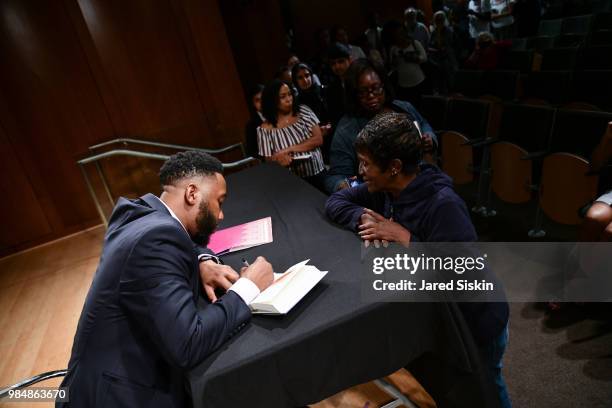 Ndaba Mandela signs a copy of his book at after In Conversation With Lydia Polgreen, Editor-in-Chief, HuffPost and Ndaba Mandela, Grandson Of Nelson...