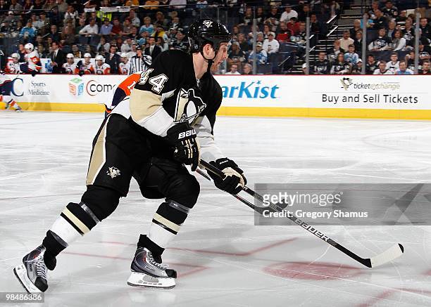 Brooks Orpik of the Pittsburgh Penguins moves the puck up ice against the New York Islanders on April 8, 2010 at the Mellon Arena in Pittsburgh,...