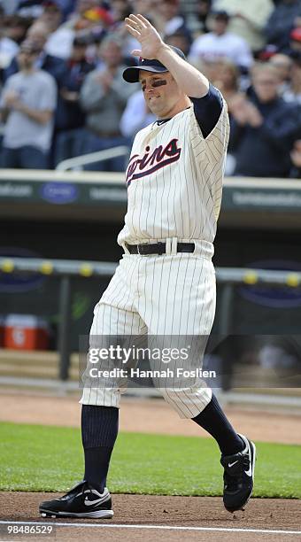 Michael Cuddyer of the Minnesota Twins runs onto the field as he is announced prior to a game against the Boston Red Sox during the Twins home opener...