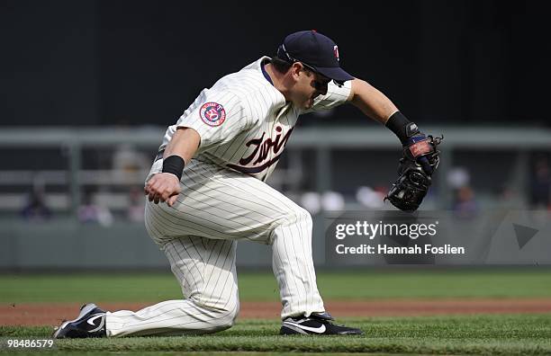 Nick Punto of the Minnesota Twins catches a throw from center fielder Denard Span in the first inning against the Boston Red Sox during the Twins...