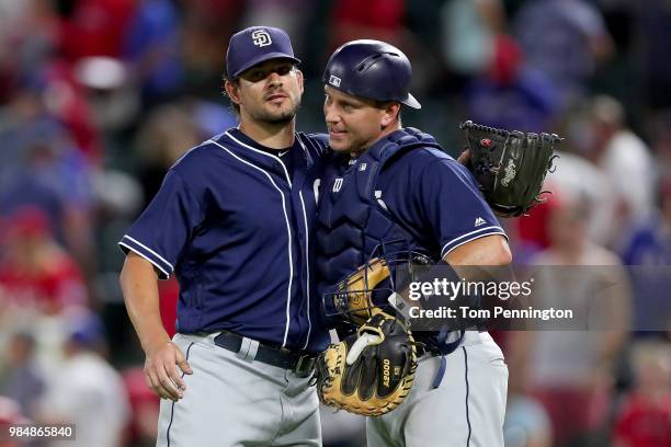 Brad Hand of the San Diego Padres celebrates with A.J. Ellis of the San Diego Padres after beating the Texas Rangers 3-2 at Globe Life Park in...