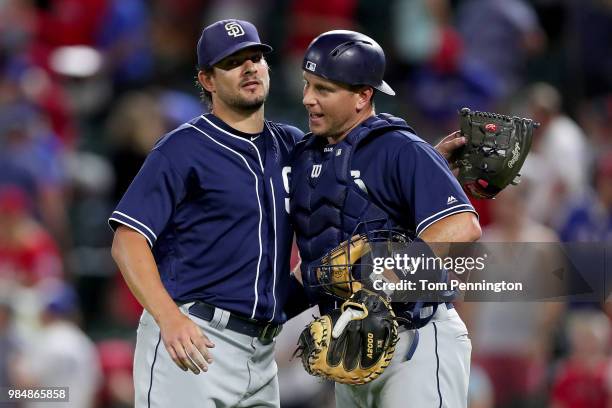 Brad Hand of the San Diego Padres celebrates with A.J. Ellis of the San Diego Padres after beating the Texas Rangers 3-2 at Globe Life Park in...
