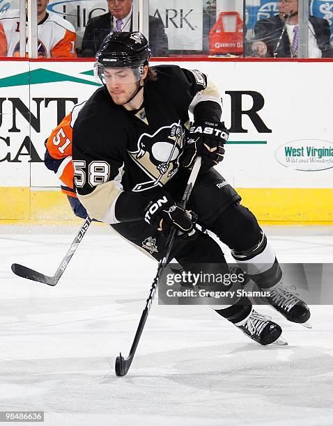 Kris Letang of the Pittsburgh Penguins controls the puck against the New York Islanders on April 8, 2010 at the Mellon Arena in Pittsburgh,...
