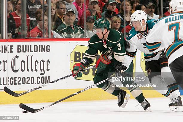 Marek Zidlicky of the Minnesota Wild and Patrick Marleau of the San Jose Sharks battle for control of the puck during the game at the Xcel Energy...