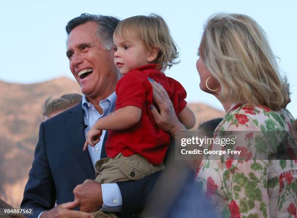 Mitt Romney his grandson Dane Romney and his wife Ann waves to supporters and declares victory on June 26, 2018 in Orem, Utah. Romney was declared...