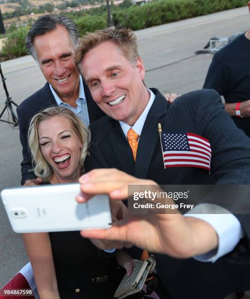 Mitt Romney takes pictures with supporters after his victory rally on June 26, 2018 in Orem, Utah. Romney was declared the winner over his challenger...